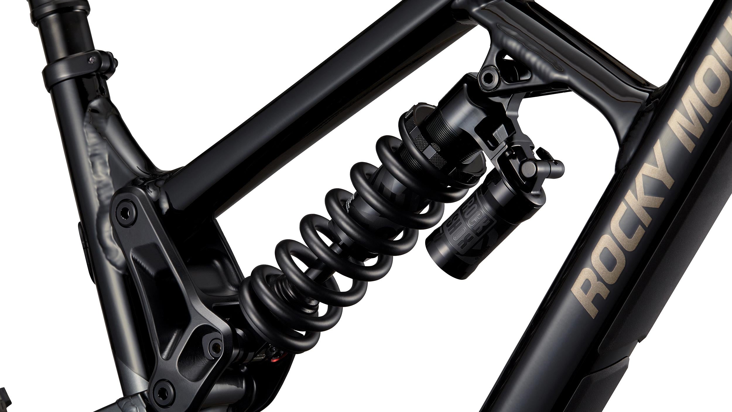 _caption_The Slayer Alloy 50 features the RockShox Super Deluxe Coil Select+ , ensuring a smooth and plush ride on the descents while allowing an efficient ride on the climbs thanks to its compression lockout.